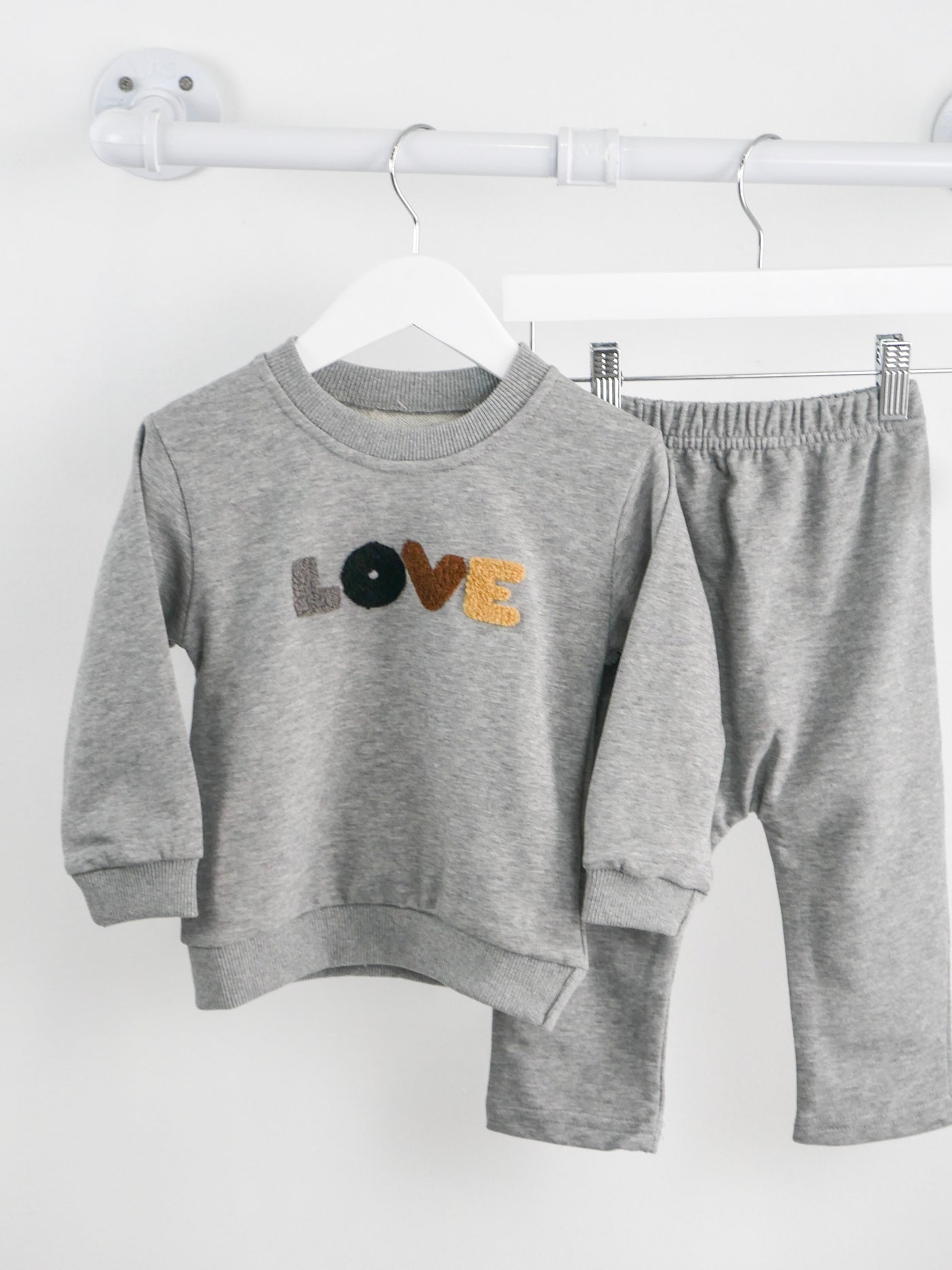 Grey Jogger set with crew neck and chenille in grey, black, brown and beige patches that spell out love