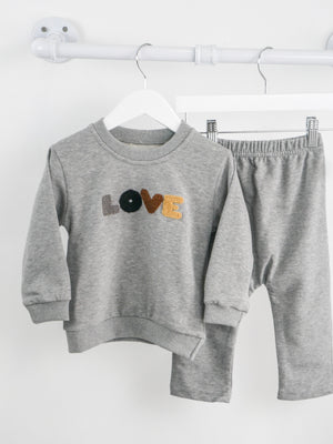 Grey Jogger set with crew neck and chenille in grey, black, brown and beige patches that spell out love